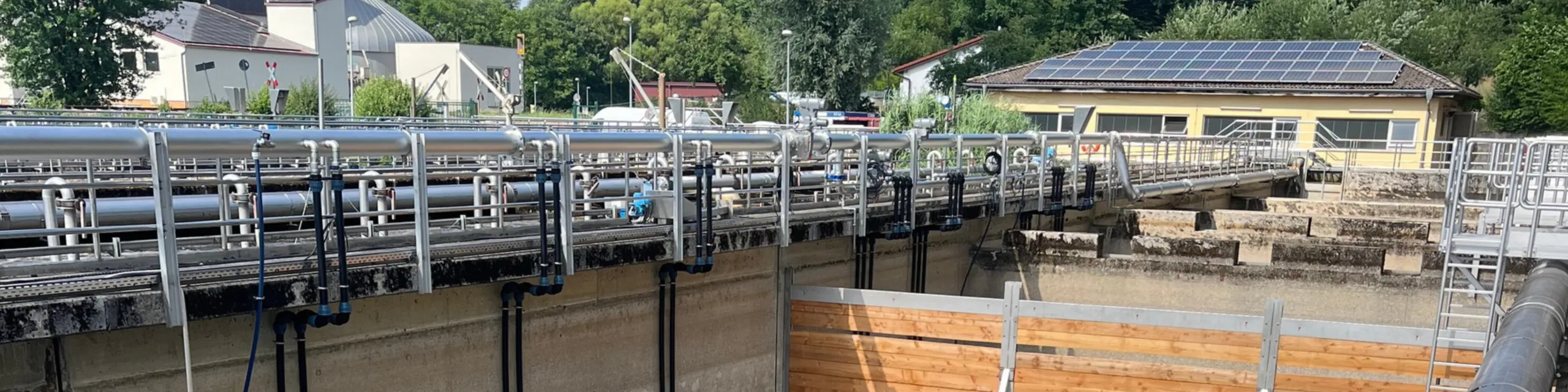 Industrial wastewater treatment facility with piping systems and solar panels
